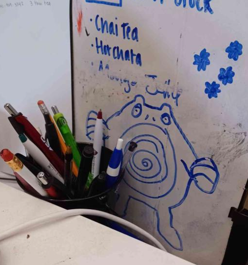 Image of a whiteboard with a drawing of the Pokemon Poliwag on it.